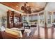 Elegant living room boasts hardwood floors, custom built-ins, and a unique wood-paneled ceiling with striking ceiling fan at 1137 N Lake Shore Dr, Sarasota, FL 34231