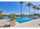 Beautiful pool area with swaying palms and tranquil waterfront views, creating a perfect setting for relaxation and entertainment at 1137 N Lake Shore Dr, Sarasota, FL 34231