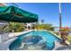 Inviting waterfront pool with a unique water feature, surrounded by well-manicured landscaping and serene water views at 1137 N Lake Shore Dr, Sarasota, FL 34231