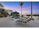 Relaxing waterfront pool area with comfortable lounge chairs and tropical landscaping, perfect for enjoying the serene water views at 1137 N Lake Shore Dr, Sarasota, FL 34231