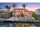 Waterfront home with a pool, dock, outdoor seating, covered patio, and views of the bay at 1137 N Lake Shore Dr, Sarasota, FL 34231