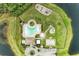 Overhead view of community pool, playground and parking area with lake on two sides at 11411 Flora Springs Dr, Riverview, FL 33579