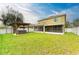 Expansive backyard view showcasing a covered hot tub and a screened patio at 11411 Flora Springs Dr, Riverview, FL 33579