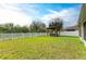 Backyard with a well-maintained lawn and a cozy hot tub under a wooden pergola at 11411 Flora Springs Dr, Riverview, FL 33579
