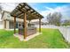 Backyard featuring a covered hot tub with a clear roof and a manicured lawn at 11411 Flora Springs Dr, Riverview, FL 33579