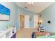 bedroom with light-blue walls, a view into the home and a view of an entertainment center at 11411 Flora Springs Dr, Riverview, FL 33579