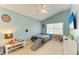 A brightly lit bedroom with vaulted ceiling and an exterior view at 11411 Flora Springs Dr, Riverview, FL 33579