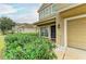 Tan home featuring a well-manicured lawn, front porch, and a two-car garage at 11411 Flora Springs Dr, Riverview, FL 33579