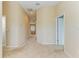 Well-lit hallway with neutral walls and carpet leading to other areas of the home at 11411 Flora Springs Dr, Riverview, FL 33579