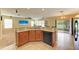 Kitchen island with breakfast bar, modern appliances, and backyard access at 11411 Flora Springs Dr, Riverview, FL 33579