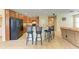 Kitchen with center island, breakfast bar, stainless steel refrigerator, and tile floors at 11411 Flora Springs Dr, Riverview, FL 33579