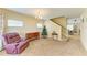 Spacious living room featuring carpet flooring and staircase at 11411 Flora Springs Dr, Riverview, FL 33579