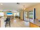 Open-concept living room featuring tile floors, ceiling fan, and backyard access at 11411 Flora Springs Dr, Riverview, FL 33579
