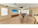 Bright and open living room featuring modern entertainment center at 11411 Flora Springs Dr, Riverview, FL 33579