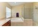 Another view of spacious main bathroom with glass shower and soaking tub at 11411 Flora Springs Dr, Riverview, FL 33579