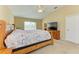 Spacious main bedroom with vaulted ceiling, carpet, and a wooden dresser with television at 11411 Flora Springs Dr, Riverview, FL 33579