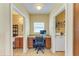 Home office setup featuring a built-in desk, cabinets, and laundry area at 11411 Flora Springs Dr, Riverview, FL 33579