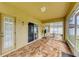 Enclosed patio with tile flooring and furniture at 11411 Flora Springs Dr, Riverview, FL 33579