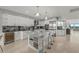 Modern kitchen featuring white cabinets, stainless steel appliances, and a marble island with bar seating at 1280 Dolphin Bay Way # 402, Sarasota, FL 34242