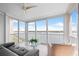 Bright living room features water views from floor-to-ceiling sliding glass doors and a modern ceiling fan at 1280 Dolphin Bay Way # 402, Sarasota, FL 34242