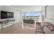 Inviting living room boasts hardwood floors, modern furniture, and a wall of windows with a beautiful water view at 1280 Dolphin Bay Way # 402, Sarasota, FL 34242