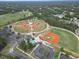 Aerial view of the community baseball field and recreational areas including a swimming pool at 13 Belcher Ave, North Port, FL 34288