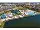 Aerial view of resort-style amenities featuring a pool, tennis courts, miniature golf and beach club at 130 Riviera Dunes Way # 1201, Palmetto, FL 34221