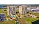 Aerial view of two condo towers offering beautiful green spaces, walking paths, and pools at 130 Riviera Dunes Way # 1201, Palmetto, FL 34221