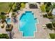 Aerial view of pool, patio, and lush landscaping at 130 Riviera Dunes Way # 1201, Palmetto, FL 34221