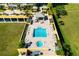 Aerial view of pool, patio, and lush landscaping at 130 Riviera Dunes Way # 1201, Palmetto, FL 34221