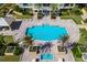 Aerial view of pool and patio with lush landscaping at 130 Riviera Dunes Way # 1201, Palmetto, FL 34221