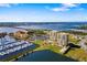 Aerial view of two condo buildings with boat docks and bridge access to waterfront community at 130 Riviera Dunes Way # 1201, Palmetto, FL 34221