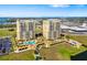 An aerial view of two high rise buildings with manicured green spaces and harbor views at 130 Riviera Dunes Way # 1201, Palmetto, FL 34221