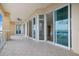 Spacious condo balcony with tile flooring, ceiling fan, and sliding glass doors with marina views at 130 Riviera Dunes Way # 1201, Palmetto, FL 34221