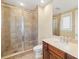 Bathroom featuring a shower with glass doors and a wooden vanity with a mirror at 130 Riviera Dunes Way # 1201, Palmetto, FL 34221