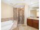 Bathroom featuring tile flooring, a walk-in shower, and a soaking tub at 130 Riviera Dunes Way # 1201, Palmetto, FL 34221