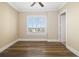 Bedroom featuring neutral walls, wood floors, and a window with blinds at 130 Riviera Dunes Way # 1201, Palmetto, FL 34221