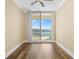 Bright bedroom featuring wood floors and a sliding glass door to a private balcony at 130 Riviera Dunes Way # 1201, Palmetto, FL 34221