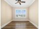 Bright bedroom featuring wood floors, a ceiling fan, and a window with shutters at 130 Riviera Dunes Way # 1201, Palmetto, FL 34221