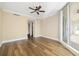 Spacious bedroom features wood floors, ceiling fan and a sliding glass door to a balcony at 130 Riviera Dunes Way # 1201, Palmetto, FL 34221