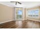 Bright bedroom featuring wood floors, ceiling fan and a sliding glass door to a private balcony at 130 Riviera Dunes Way # 1201, Palmetto, FL 34221