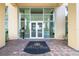 Building entrance with double doors, and black welcome mat at 130 Riviera Dunes Way # 1201, Palmetto, FL 34221