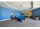 A spacious game room features a billiard table and stylish decor at 130 Riviera Dunes Way # 1201, Palmetto, FL 34221