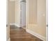 Hallway featuring wood flooring, neutral walls, and white trim offering a transition within the home's interior at 130 Riviera Dunes Way # 1201, Palmetto, FL 34221