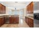 Kitchen features wood cabinets, granite countertops, and stainless steel appliances creating a desirable and modern cooking space at 130 Riviera Dunes Way # 1201, Palmetto, FL 34221