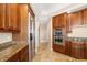 Elegant kitchen with stainless steel appliances, granite countertops, and ample cabinet storage for seamless cooking at 130 Riviera Dunes Way # 1201, Palmetto, FL 34221