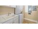 Laundry room features a white washer and dryer, sink, and neutral walls at 130 Riviera Dunes Way # 1201, Palmetto, FL 34221