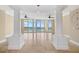 Bright, airy living room featuring travertine floors, columns, and a wall of sliding glass doors at 130 Riviera Dunes Way # 1201, Palmetto, FL 34221