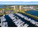 Aerial view of a waterfront marina full of docked boats with luxury condos in the background at 130 Riviera Dunes Way # 1201, Palmetto, FL 34221