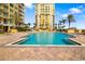 Large outdoor pool with towers and lounge area at 130 Riviera Dunes Way # 1201, Palmetto, FL 34221
